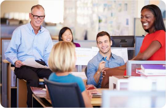 A group of people looking at each other in a seated circle talking about time and attendance tracking systems