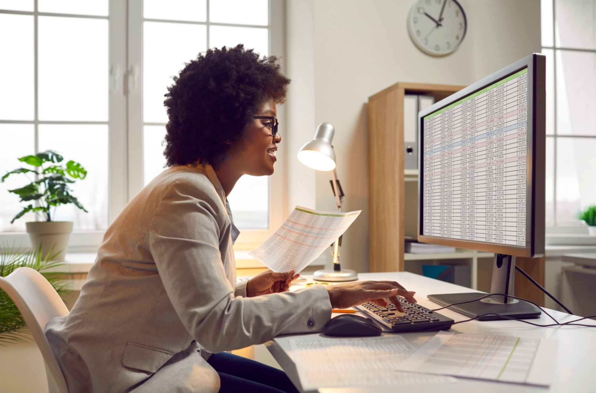 Employee working evening or overnight hours and looking at her payroll spreadsheet, visualizing shift differential pay