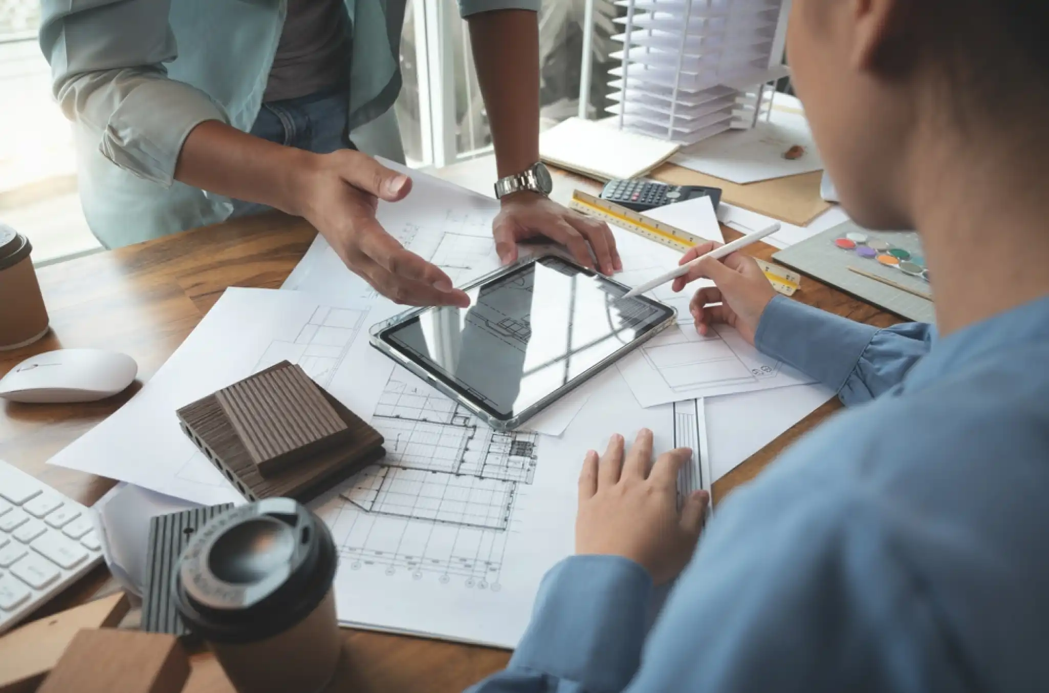 Employees reviewing a breakdown of job costs by task and role in a time tracking system, related to job costing strategy