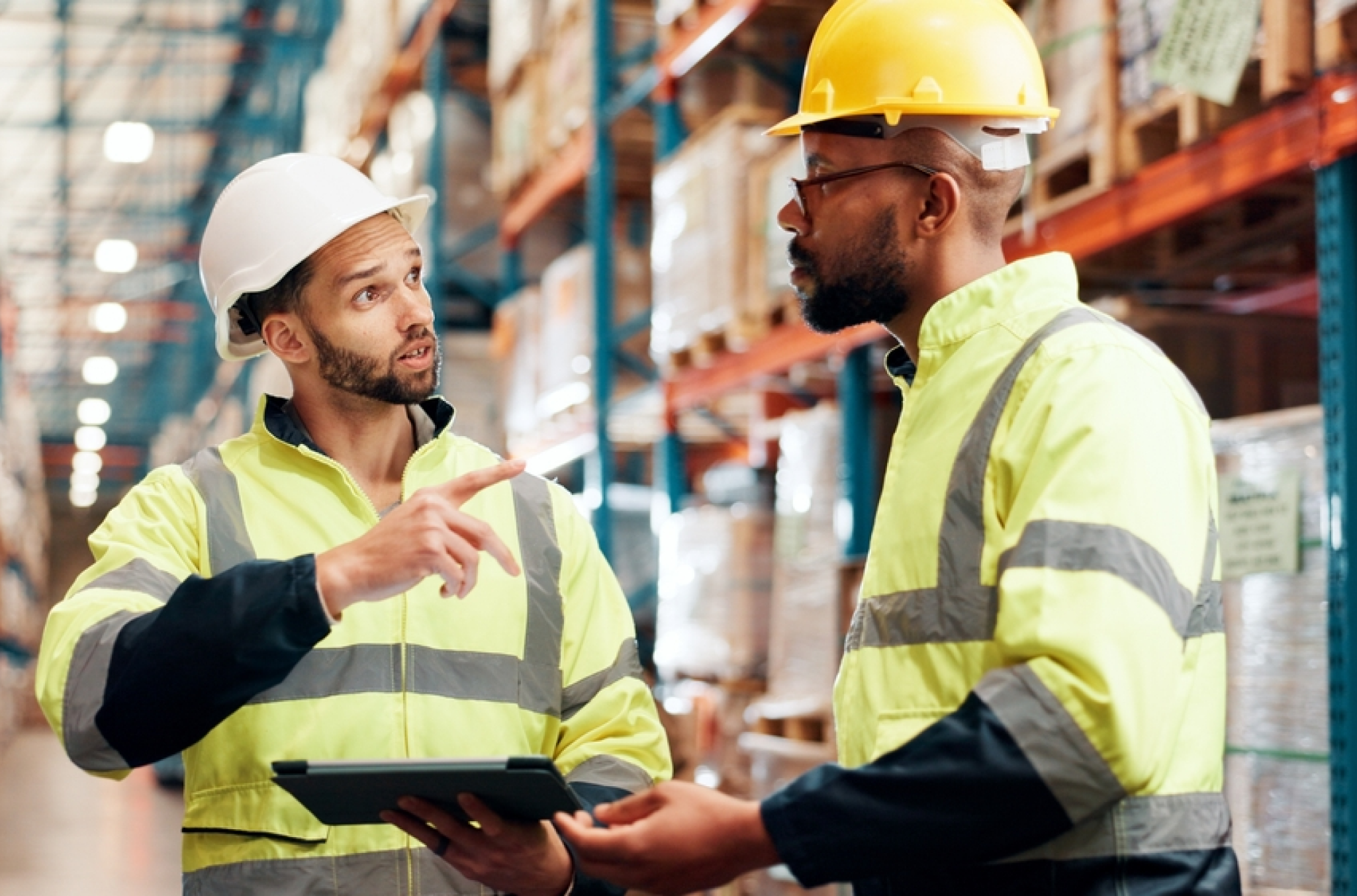 two construction workers debating on whether to integrate employee scheduling and time tracking software