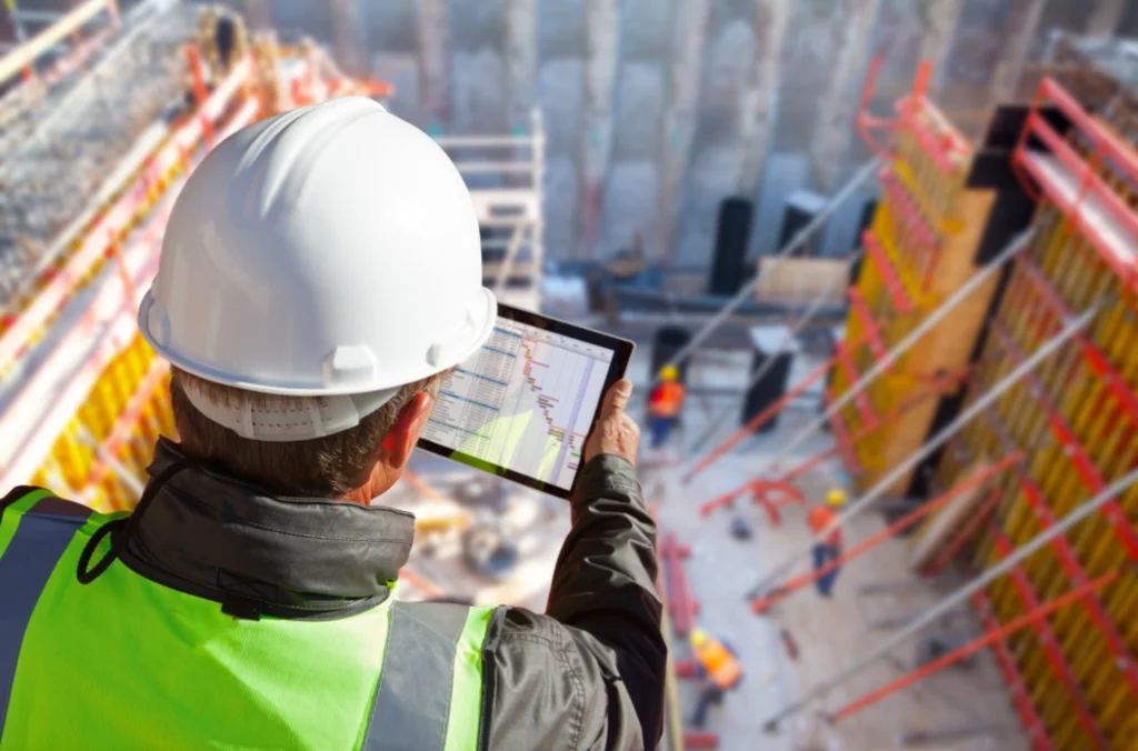 Construction worker overlooking checklist and reporting tools for labor law compliance