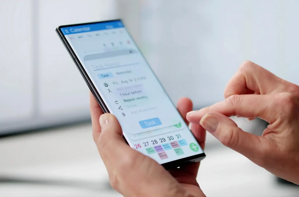 Someone tapping an app on their phone which demonstrates manual vs automated employee scheduling, where the feature they are showing has their scheduling autopopulated based on availability